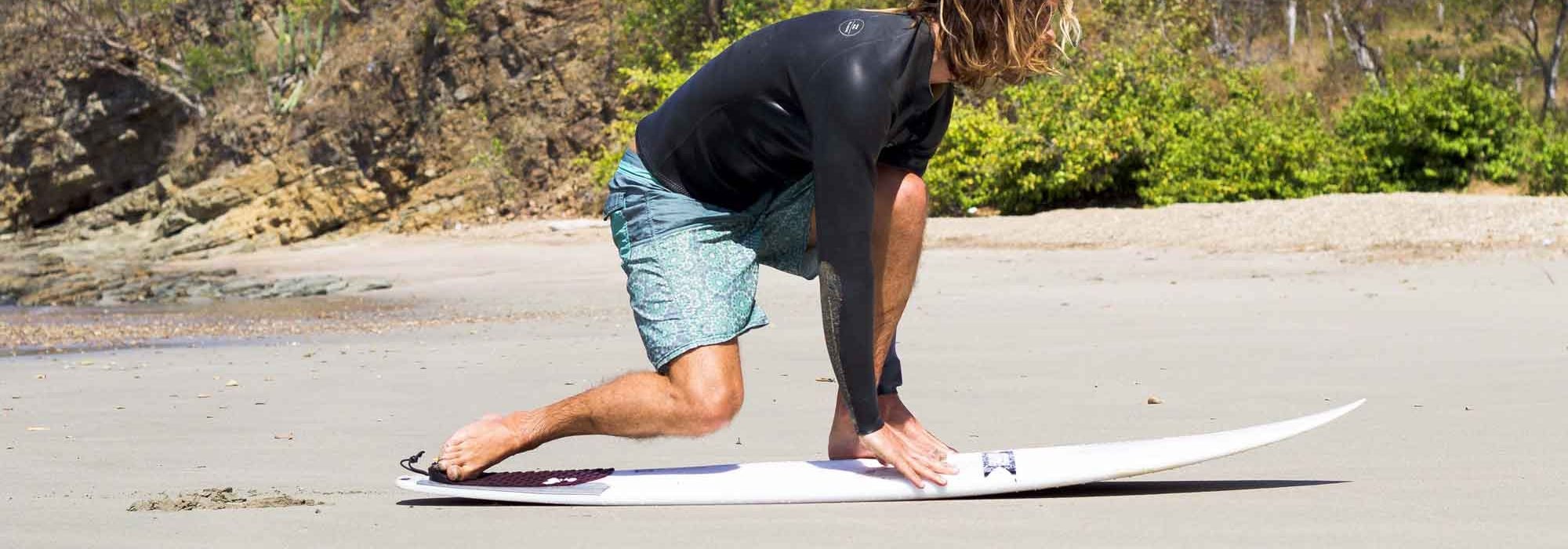 Front Foot Between Hands on the Surfboard